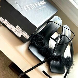 Beautiful black strap heels with a little feathers 🫶🏻. Used once.